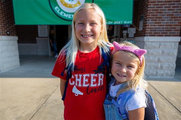a girl student and boy student smiling in front of CCES